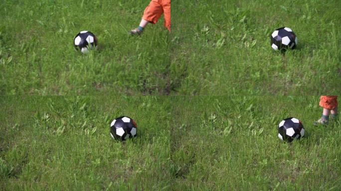 一个孩子在长草丛中踢球，脚的特写镜头