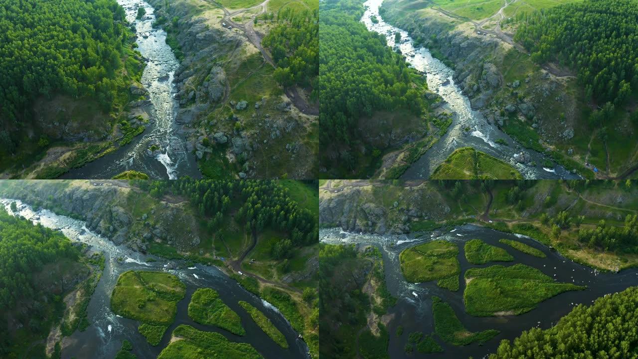 从无人机上可以鸟瞰风景如画的山谷和高山河流。岩石海岸上的绿色草地和森林。