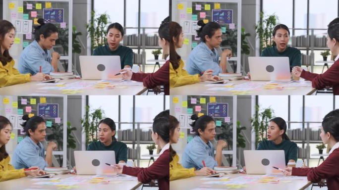 亚洲女性领导者建议ux/ui设计师关于现代办公室桌上的移动应用界面线框设计。创意数字发展机构