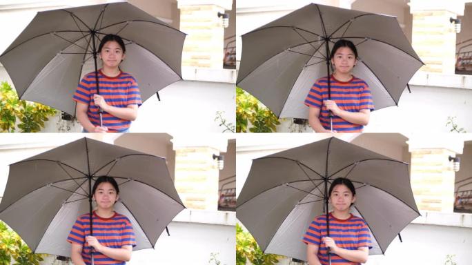 亚洲女孩在雨天打伞