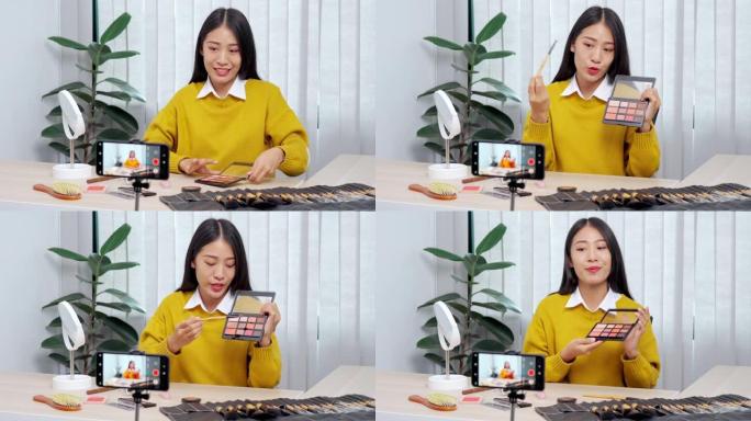 4k视频片段的年轻亚洲女性博客录制vlog视频教程和评论推广产品与化妆化妆品在社交媒体直播