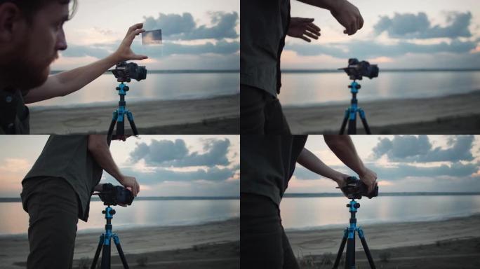摄影师通过滤光片观察并将其放在固定在三脚架上的相机上，对其进行调整以进行拍摄。河上风景如画的景色