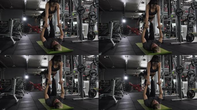 健康的两个人年轻的亚洲夫妇在健身健身房做铺板运动，男人和女人一起锻炼健康的生活方式健美肌肉。