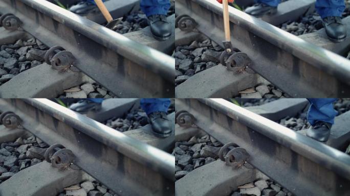 铁路工人的近距离视图用锤子检查铁路的适用性