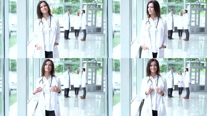 快乐的年轻欧洲女医生穿着白色医用外套和听诊器，看着相机。微笑的女医师在医院办公室摆姿势