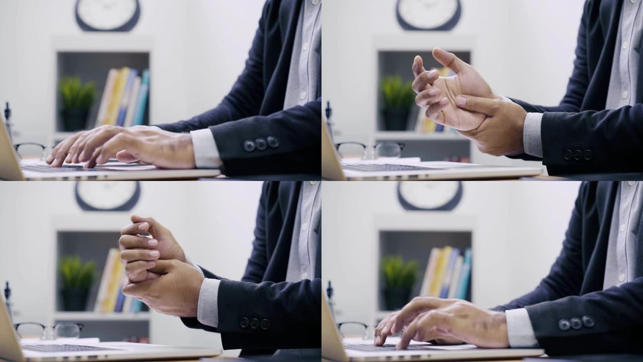 办公室综合症概念。一个商人在计算机上工作，当他使用手指和手腕时，他感到疼痛和酸痛，他试图松开手。4k