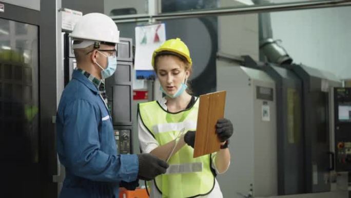 工厂工程师检查机器设备。穿戴防护设备。安全帽，防止事故发生。在操作或工业工厂中防止灰尘或冠状病毒的口