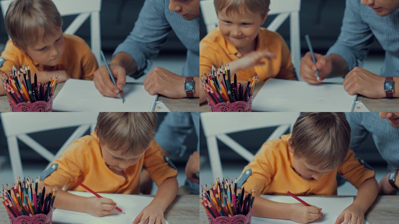 父子用彩色铅笔在纸上绘画的选择性聚焦