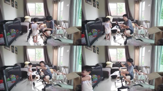 亚洲爸爸在家中客厅安装新婴儿推车