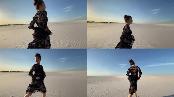 穿着蕾丝黑色连衣裙的女人在沙漠中奔跑。