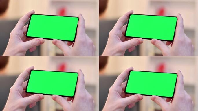 在智能手机的水平绿色色度键屏幕上观看
