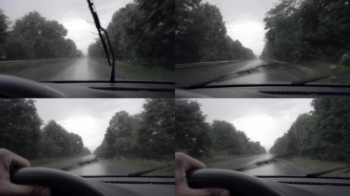 汽车驾车穿越雨水，潮湿的车窗和车窗清洁剂，在暴风雨中行驶