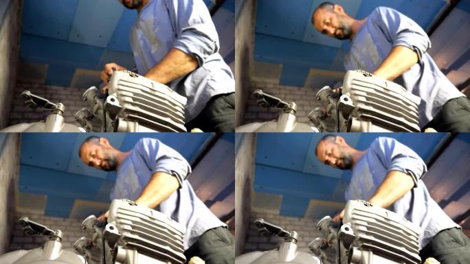 大胡子机械师修理一些车辆的电机。汽车大师在车库或车间固定摩托车发动机。从事维修汽车或摩托车的人。关闭