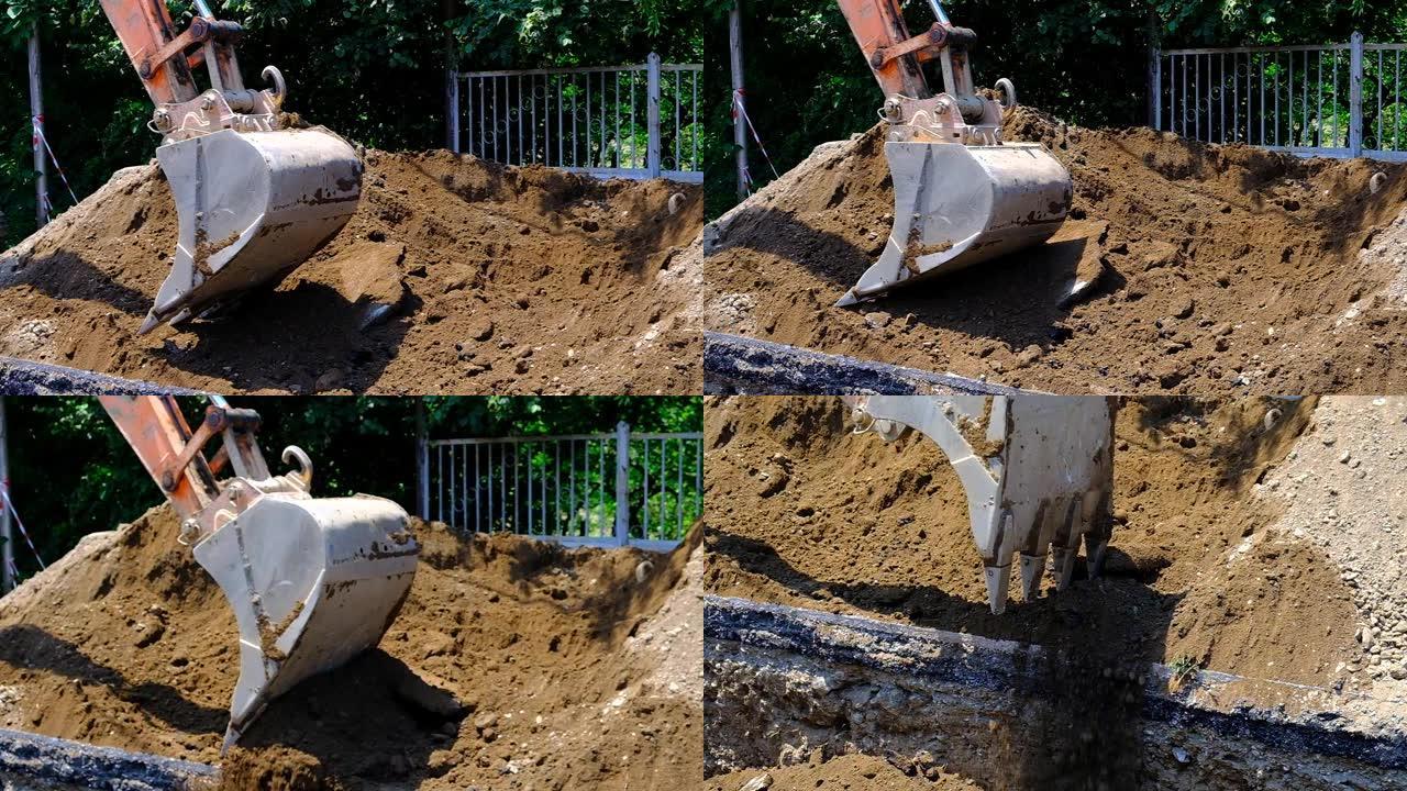 挖掘机将土壤放入沟渠中。