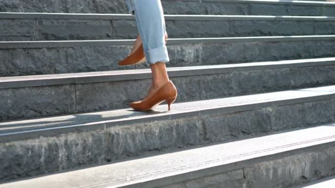 女人的腿美女穿上红色高跟鞋走在街上。美容与健康概念