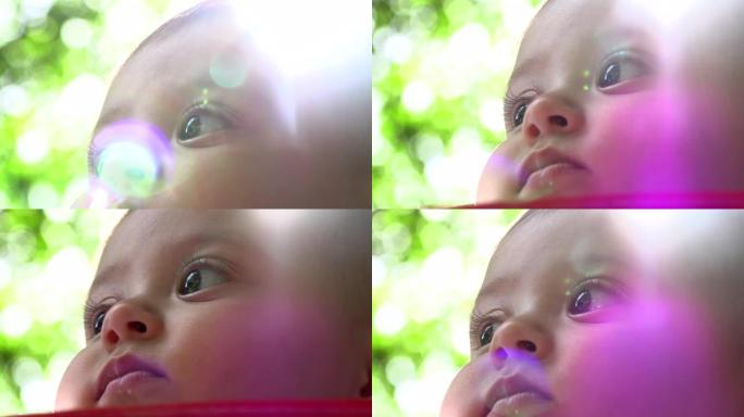 户外美丽的婴儿脸肖像，晒太阳婴儿观察