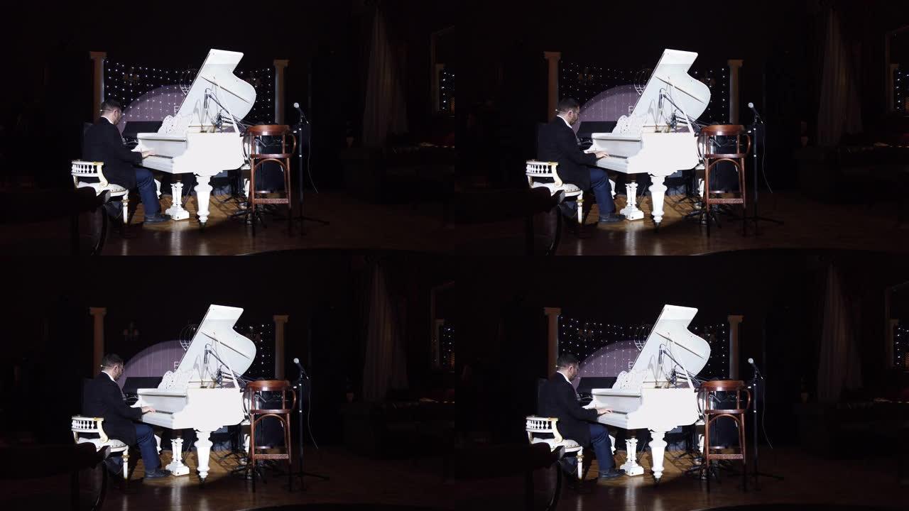 钢琴家在俱乐部室内背景下表演自己的音乐的镜头