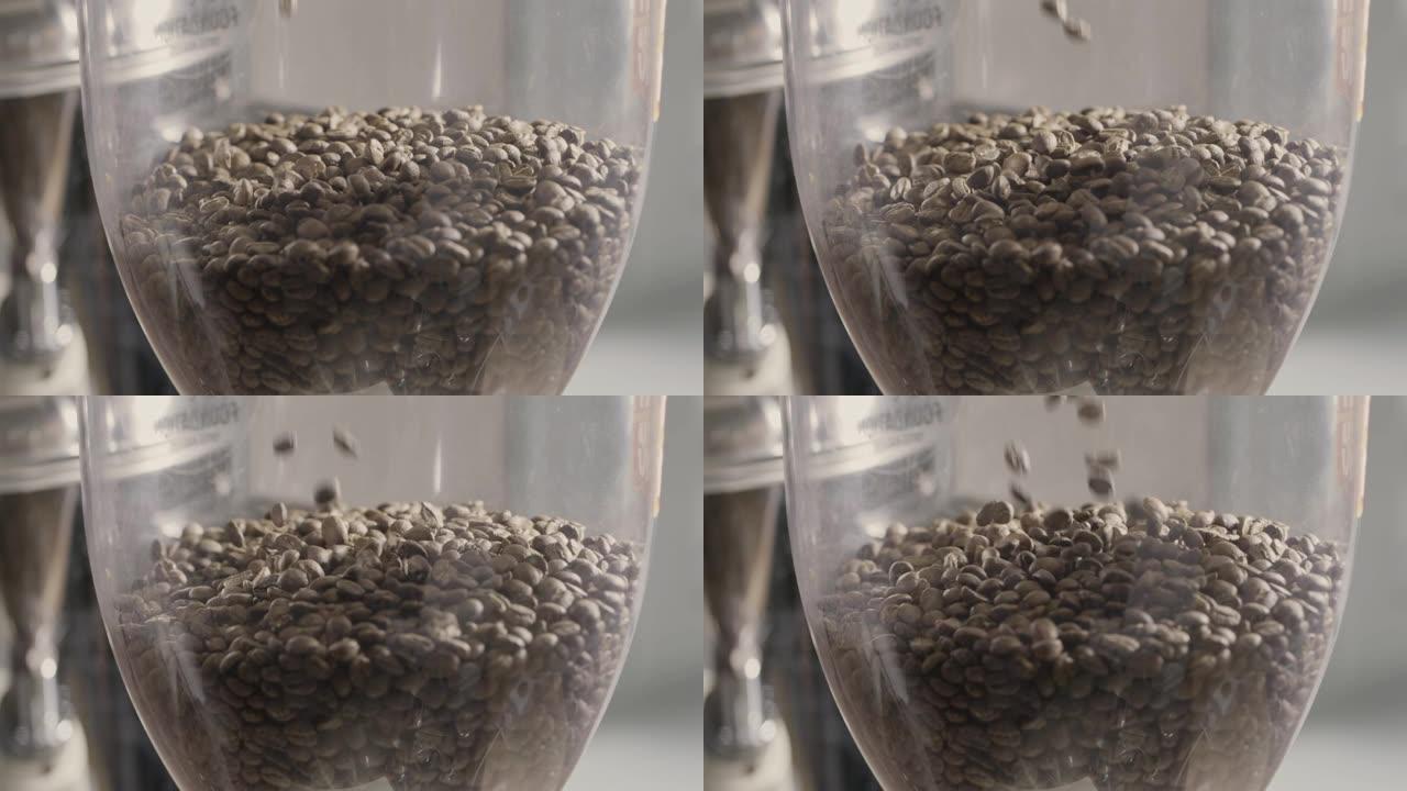芬芳的烘焙咖啡豆落入咖啡研磨机。慢动作，全高清视频，240fps，1080p.