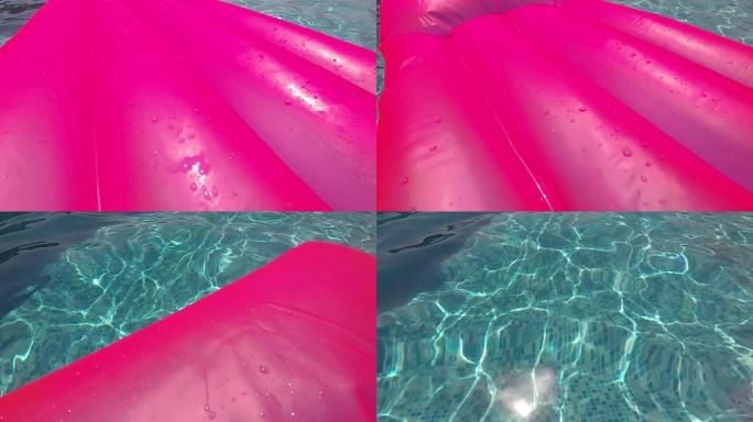 游泳池上的粉色橡胶床垫