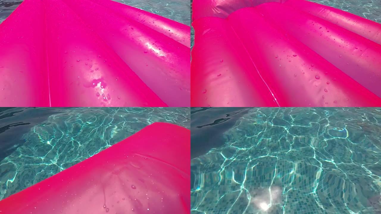 游泳池上的粉色橡胶床垫