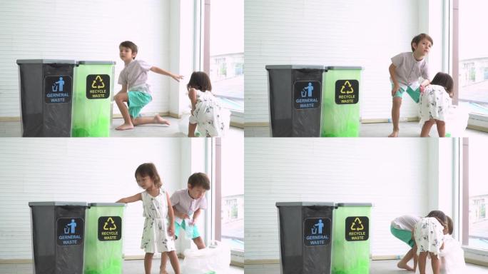 混合比赛的奥地利泰国男孩和英国泰国女孩学习，帮助将塑料瓶分离到可回收垃圾箱中。在家庭中教授高加索儿童