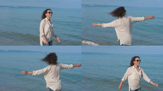 女人在海边旋转。