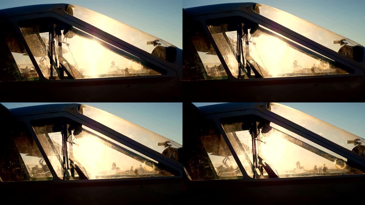 特写，日落时分，太阳的光线穿过一架复古飞机的驾驶舱