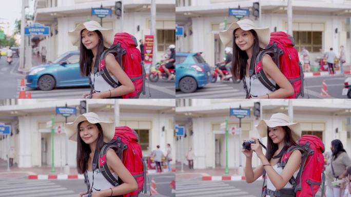 20-30岁的亚洲女摄影师。桥梁背包旅行博客作者在泰国散步时使用相机拍摄在线旅行频道的视频片段。