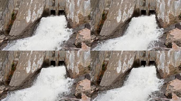 从旧水坝底部流出的水