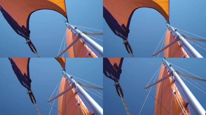 在蔚蓝的天空下，带staysail和mainsail的帆船桅杆的视图