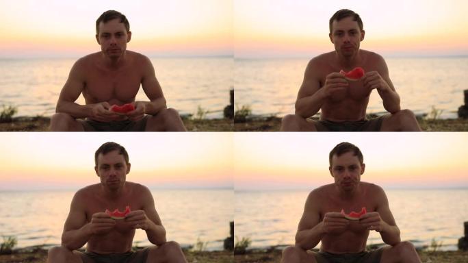自信的男人坐在海边吃西瓜
