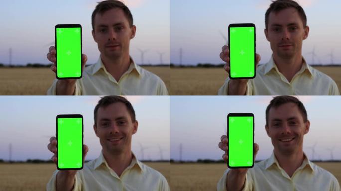 带有空绿色屏幕的Man show智能手机
