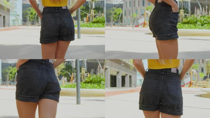 穿着短牛仔黑色短裤的性感迷人女人