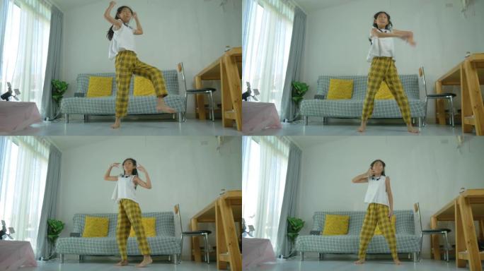 快乐的亚洲女孩在家练习舞蹈，生活方式理念。