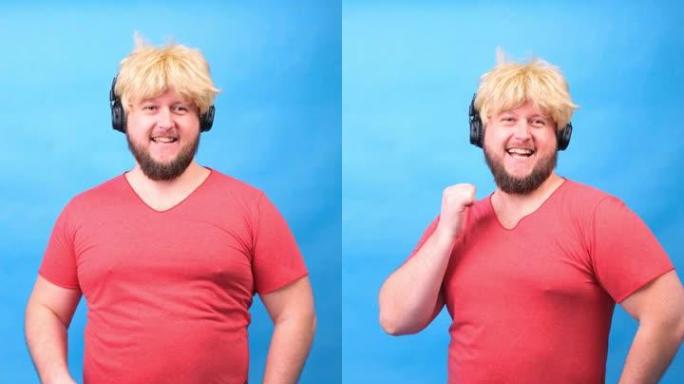 戴着耳机和戴着粉色t恤的假发的滑稽胖乎乎的男人穿着绿色哑铃，在蓝色背景上大笑