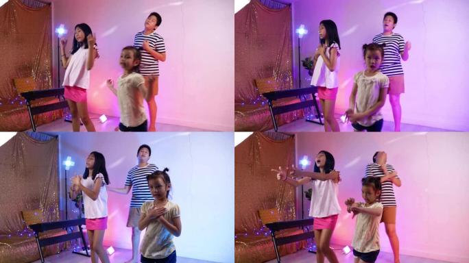 快乐的亚洲儿童在家庭聚会中跳舞，搭配led灯，生活方式理念。