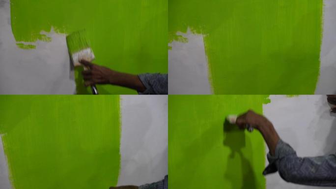 男人在墙上画绿色