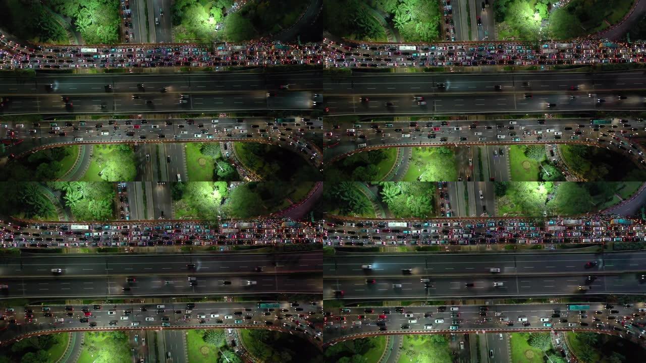 雅加达市市中心夜间照明繁忙交通街路口空中俯拍全景4k印度尼西亚
