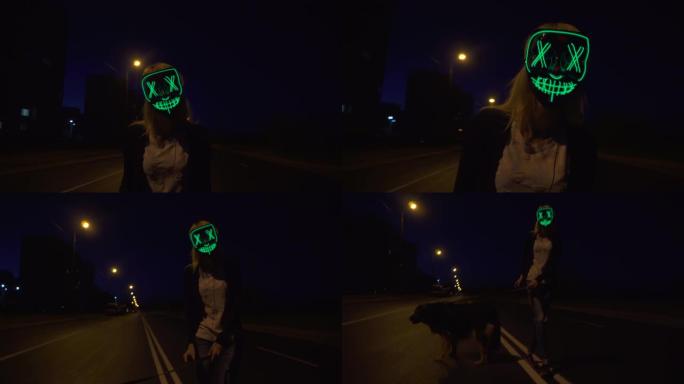 狂欢开始时，我突然出现。一个男人戴着异国情调的发光二极管面具。面具点亮，发光，街道，夜晚，城市，灯光