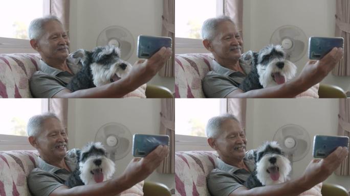 高级男子和他的雪纳瑞狗一起自拍有趣。