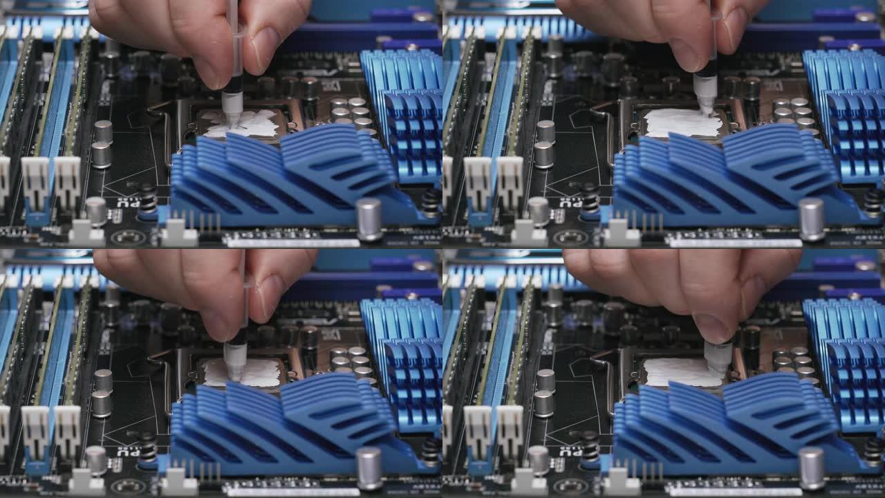 建立计算机，特写视图，4K。一名男性服务人员在CPU上涂上一层导热膏。