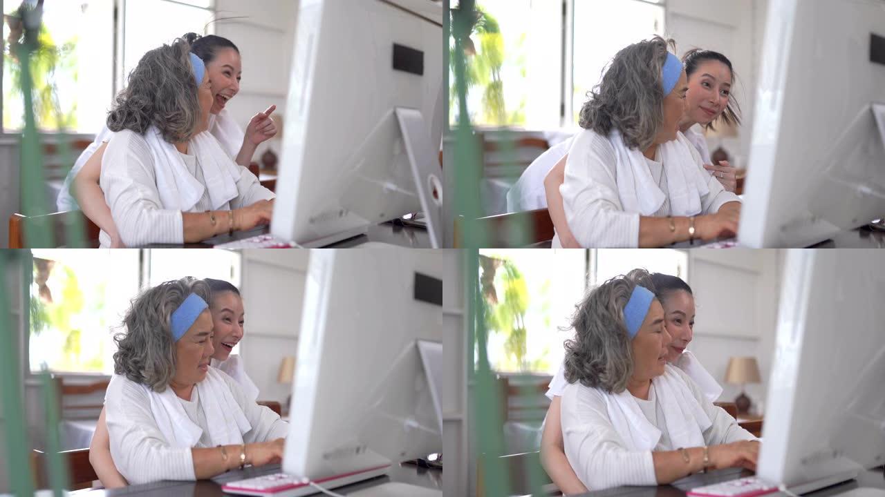 亚洲高级妇女和女儿在家中使用计算机进行视频会议