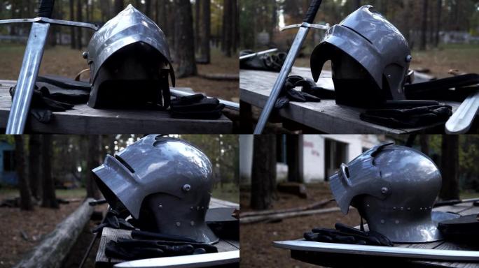 铁头盔、剑和皮手套站在木桌旁