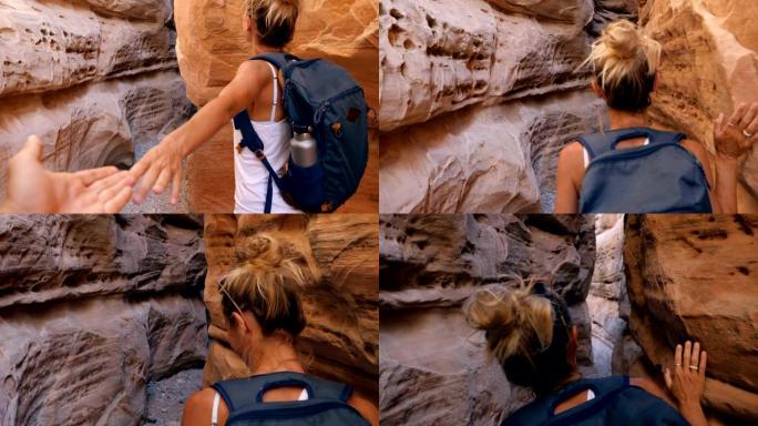 摄像机跟随徒步旅行者进入内华达沙漠的一个狭窄峡谷。人们徒步旅行，冒险旅行。一个徒步旅行者走进狭窄的峡