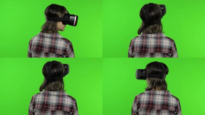 年轻女孩使用虚拟现实应用头盔玩模拟游戏。女人看虚拟现实3d视频