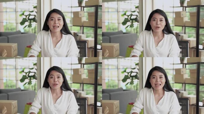一名中年亚洲妇女正在通过视频通话打招呼，她正在通过社交媒体在线开展业务。