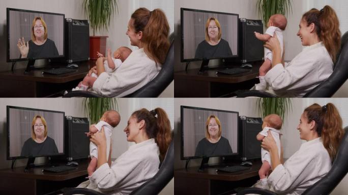 母亲和婴儿在享受家庭联系的新生婴儿面前挥舞着电脑进行视频聊天。