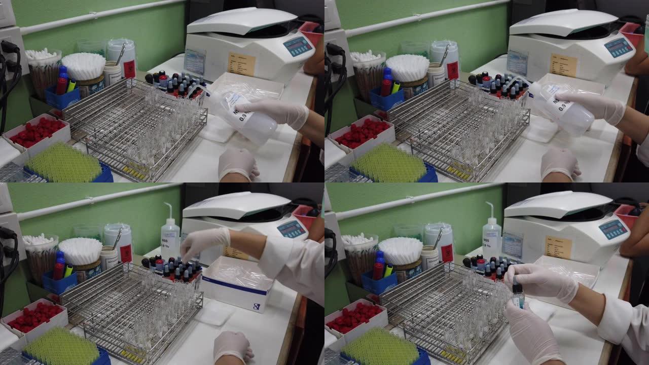 医疗技术人员正在使用血液样本分析