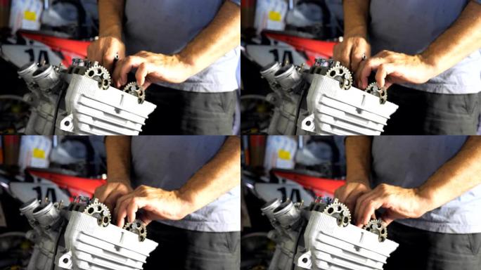 拆卸的摩托车发动机视图。专业机械师修理电机的手。修理工在车库或车间工作。从事维修汽车或摩托车的人。特