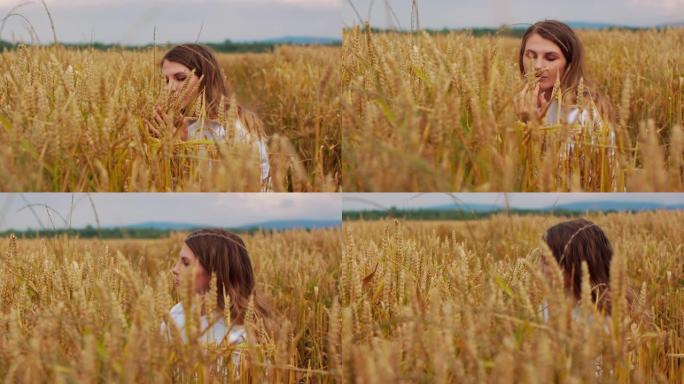 一个年轻的女孩走过田野的麦穗。美丽的无忧无虑的女人享受大自然，在麦田里用手触摸